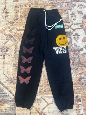 CHNGE Black Joggers with Orange Butterflies & Gold Smiley Size XS